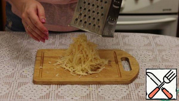 Grate the cheese on a medium grater.
