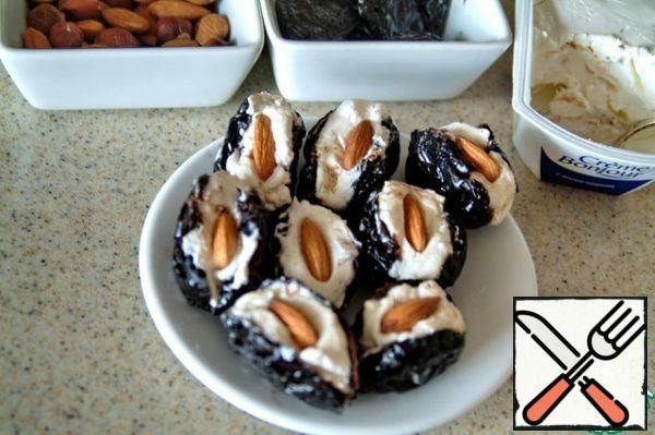 Prunes cut on one side,
stuff with cottage cheese cream,
stick in the inside of the cream hazelnuts or almonds.