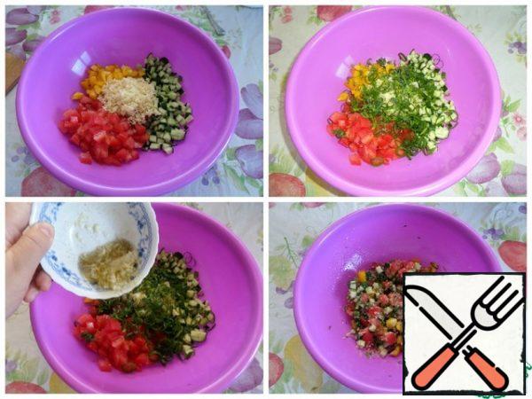 We are collecting our salad. Put the chopped vegetables, couscous, greens in a cup. Add the salad dressing. Mix well.