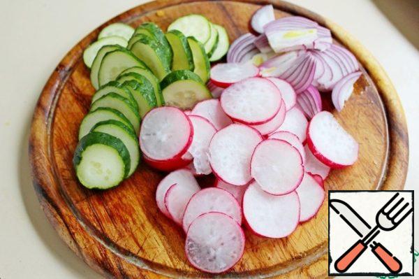 Cucumber and radish cut into thin slices, onion-feathers.