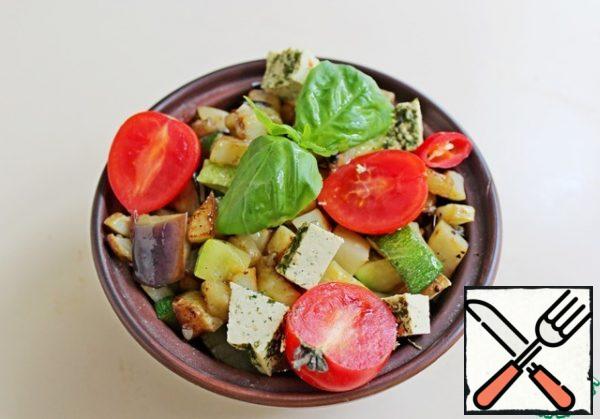 Arrange in serving salad bowls, top with sliced tofu, chili rings, cherry tomatoes and garnish with basil.
Serve the salad immediately.