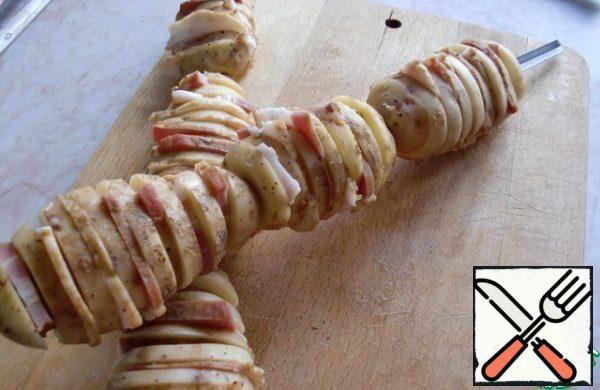 Place the potatoes on the skewers.