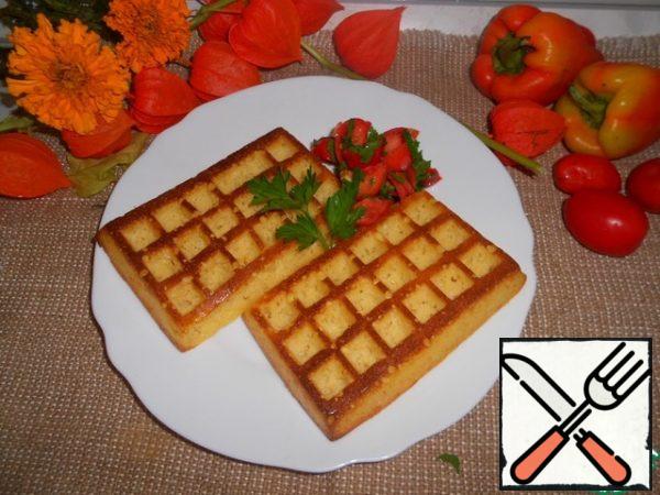 For tomato salsa, chop tomatoes and herbs, add salt and pepper to taste and pour lime juice. Serve waffles with tomato salsa.