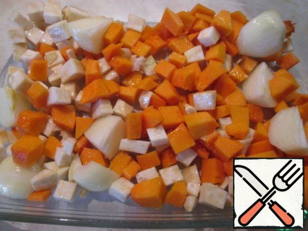 Preheat the oven to 200 degrees. Wash the beets thoroughly, wrap them in foil, and put them in the oven for one hour. Cut the pumpkin and celery into cubes, and the onion into quarters. Put the vegetables in a baking dish, season with salt and pepper, and pour over the oil. Bake until soft, about 30 minutes.