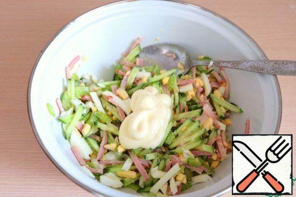 Season the salad with mayonnaise.
