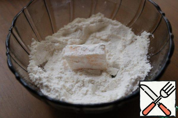 Cut the cheese into pieces and pan in flour.