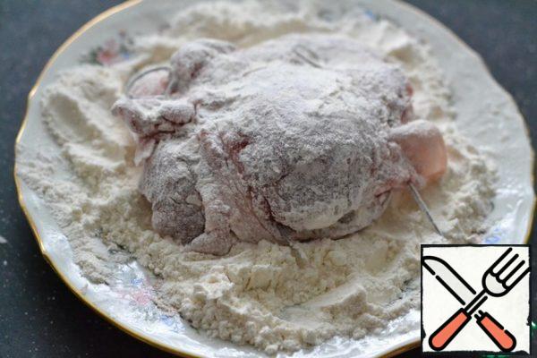 Roll the prepared meat in flour.