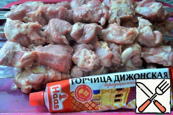 Light the grill to gray coals. Thread the meat on skewers.