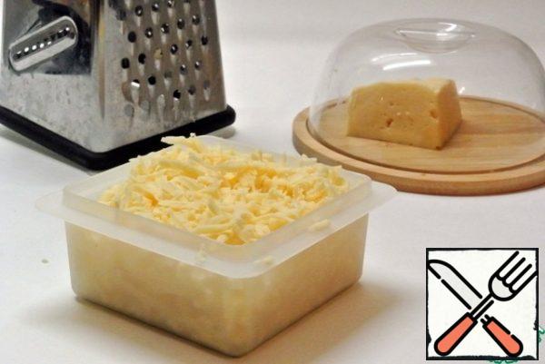 Grate the cheese on a coarse grater.