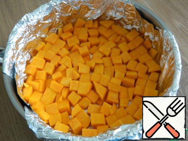 Put half of the sliced pumpkin in a greased baking dish.