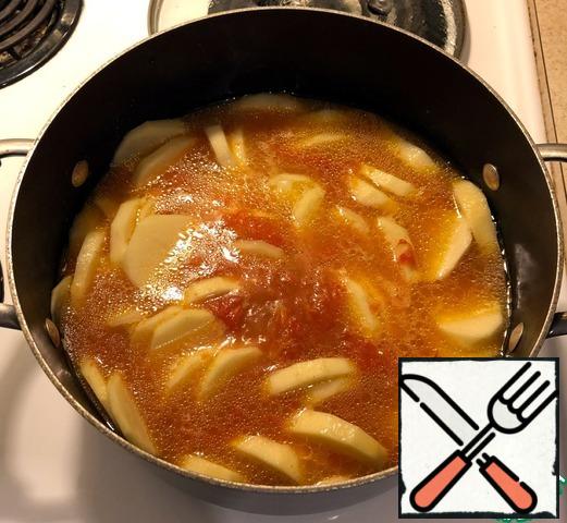 Put the potatoes in the tomato broth. As you can see in the photo, there is no need to add water. We wait until the broth with potatoes boils and move on to the next stage.