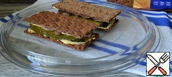 Spread another loaf and put it on the meat, sauce down, press lightly.