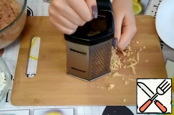 Grate the cheese on a coarse grater.