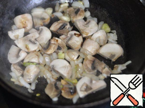 Fry the mushrooms with onions until golden brown.