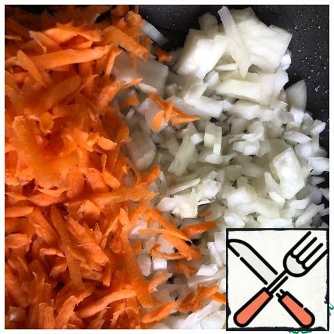 Cut the onion into a small cube, grate the carrots on a coarse grater. Fry the vegetables until tender in vegetable oil. Cool down.