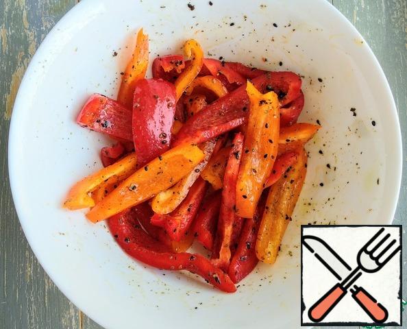 Transfer the pepper slices to a bowl, pour over the olive oil, add salt and spices. Mix thoroughly.