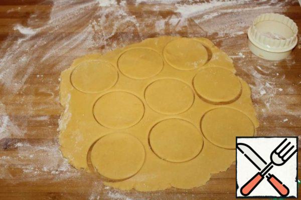 Divide the dough into two parts for convenience. Knead a little and roll out each piece into a layer 5 mm thick. Cut out circles with a diameter of 6 cm