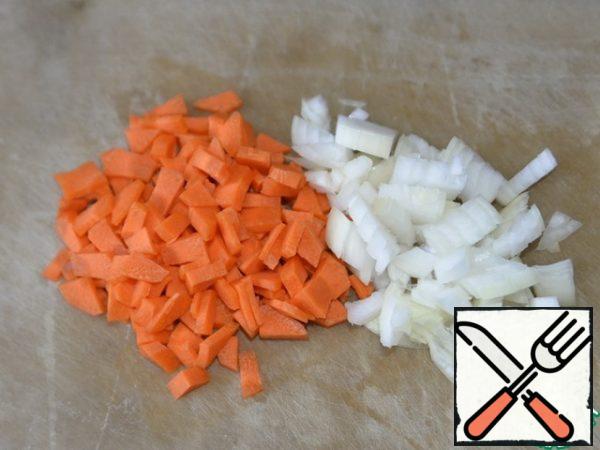 Vegetables are washed, cleaned, cut into small cubes onions and carrots.