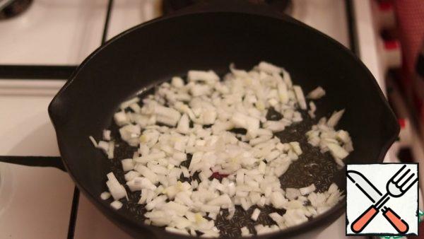 In a preheated frying pan, pour a little vegetable oil and fry the onion until transparent.