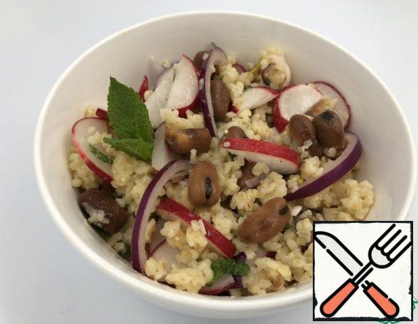 Add the beans to the still hot bulgur, stir, and cool. Add the chopped red onion, mint and radish to the bulgur and beans.
For the dressing, mix the juice and zest of lime, mustard, vinegar, honey, olive oil, chopped hot pepper. Mix the dressing and the rest of the ingredients.