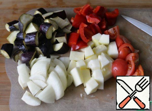 The number of vegetables, of course, is arbitrary and to your taste. Take: eggplant, zucchini or zucchini, bell pepper, onion, tomatoes. Wash, clean and cut into large pieces.