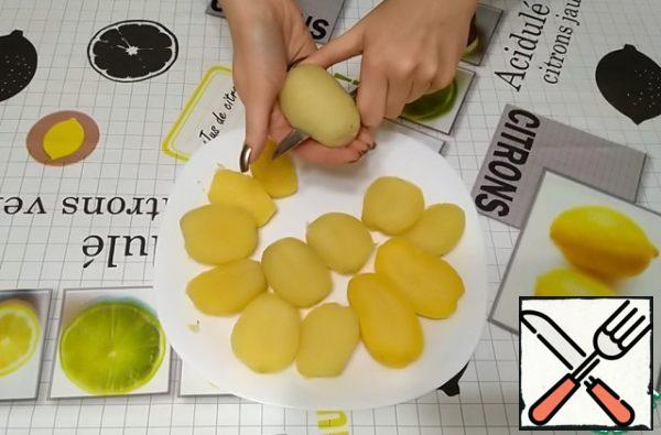 The cooled potatoes need to be peeled.
Each potato is cut in half lengthwise.