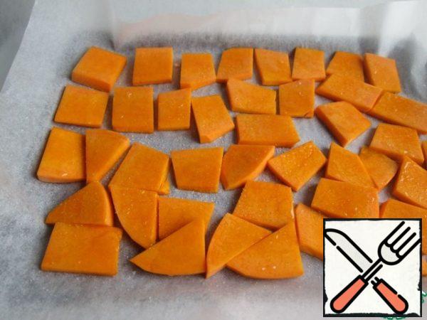 Place the baking paper on a baking sheet, lightly brush with vegetable oil and lay out the pumpkin. Top with vegetable oil and salt. Put in the oven for 20 minutes at a temperature of 200 degrees.