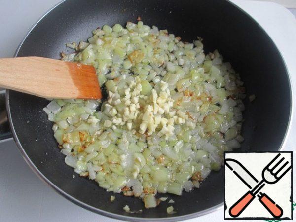 Fry the onion until transparent (and slightly golden) and add the chopped garlic. Stir and simmer for 1 minute.