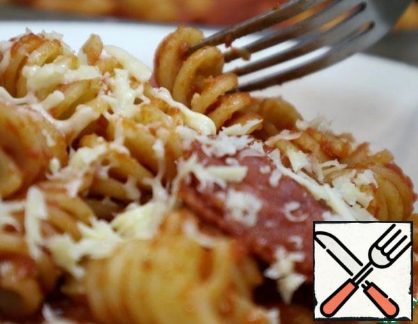  Add salt and pepper, remove the garlic and simmer for a few minutes. Combine with fusilli paste and sprinkle with grated cheese.