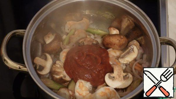 Add the mushrooms and Tom Yam paste, mix well, and simmer for a couple of minutes.