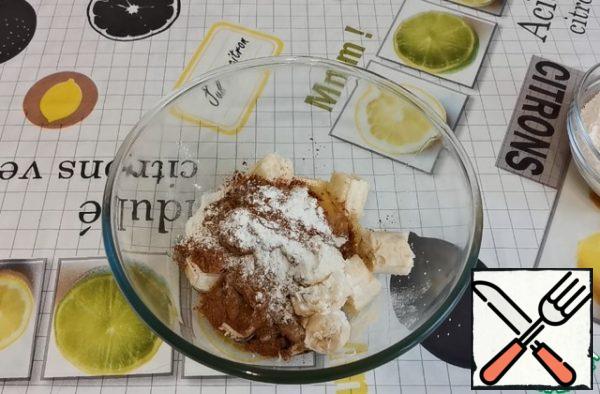 In bananas, we break the eggs. Add vegetable oil, cocoa powder, baking powder.