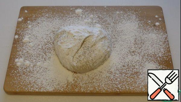 Since the dough is very sticky, we sprinkle cornstarch on the board, along the bottom of the dough, too.