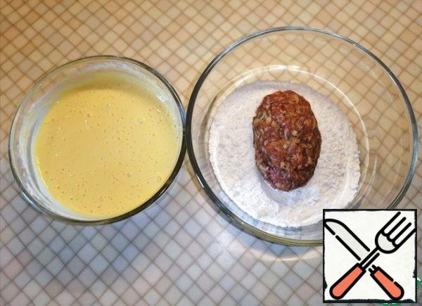 Roll the cutlets in flour and dip them in batter.