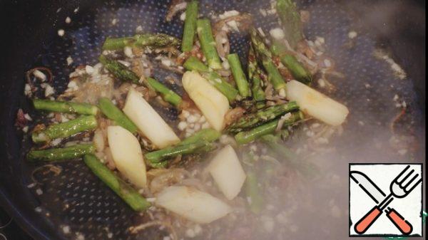 Add garlic, fry a little, pour the wine, evaporate the alcohol
