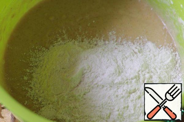 Add the flour in several batches and mix well.