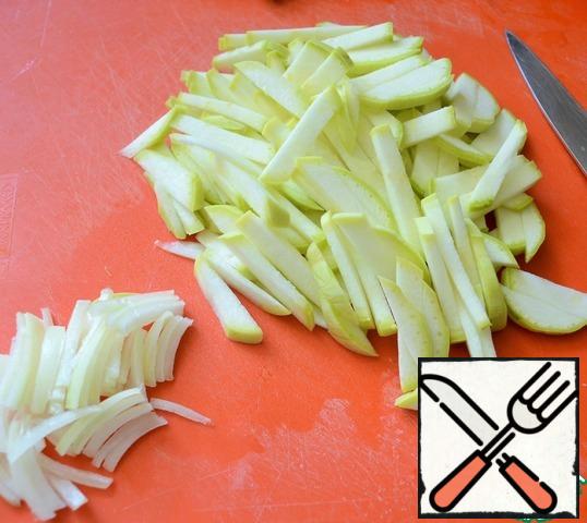 Zucchini and onion cut into chunks.