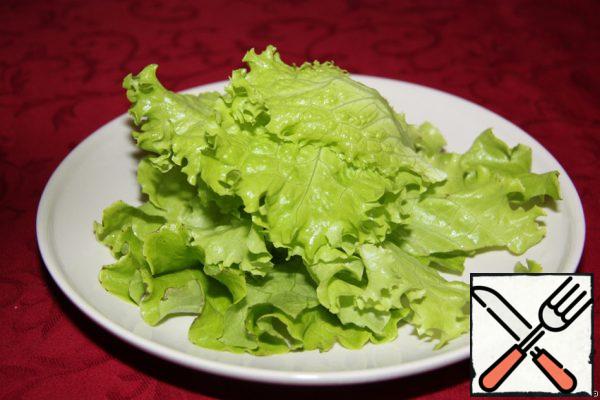 Lettuce leaves spread out in a pile.