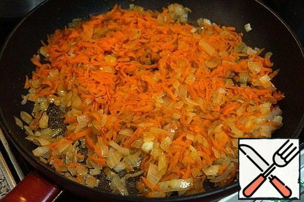 Fry the onion until soft, add the carrots to it.