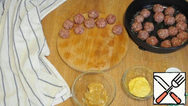 From the minced meat, we form small balls, fry in butter on all sides.
