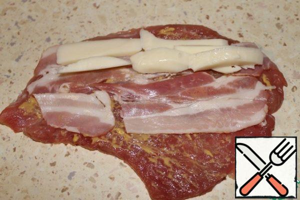 Put the bacon and cheese on top of the mustard.