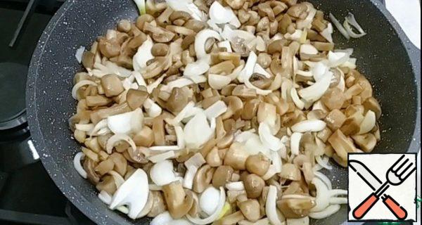 Add the onion and stir. Fry the mushrooms and onions until golden brown.