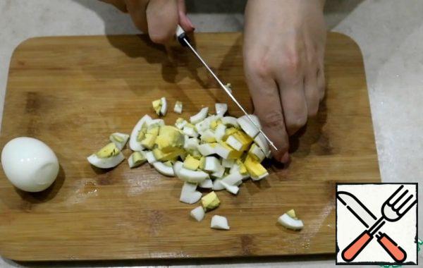 Boil the eggs (I cook them for 10 minutes) and cut into cubes.
