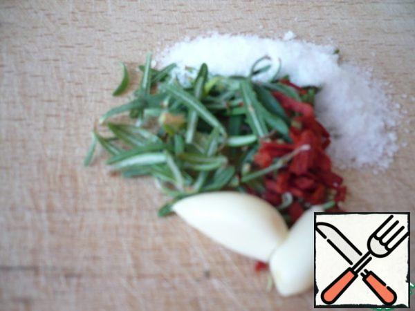 On a cutting board, pile the rosemary leaves, garlic, 2 tsp salt, red pepper flakes and chop with a large knife to a paste.