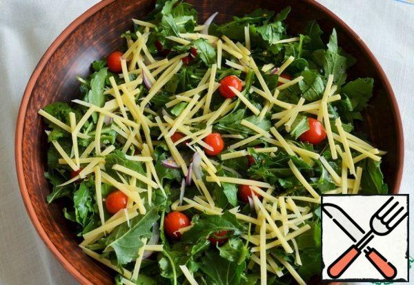 Add cherry and cheese straws to the greens.