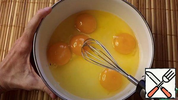 In a bowl, whisk 5 chicken eggs.