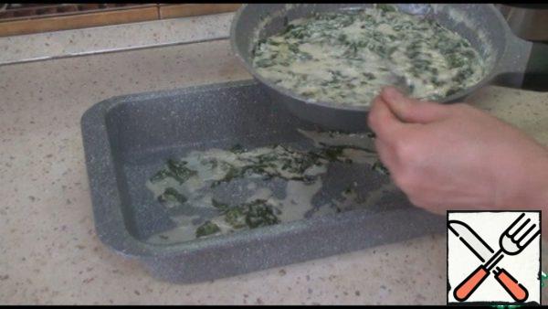 In a baking dish, spread half of the spinach filling.