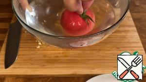 Pour boiling water over the tomato and remove the skin.