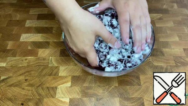 Roll the cherries in flour.