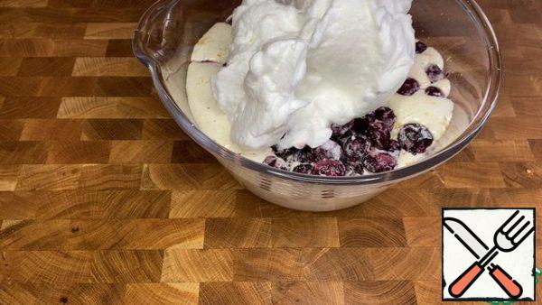 Add the cherries and the hard-beaten foam of egg whites + 50 g of sugar to the dough.
