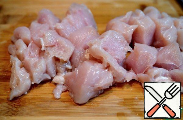 Cut the chicken breast into cubes.